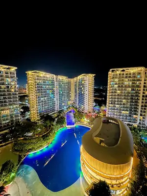 a view of a city at night with tall buildings at Azure Staycation in Manila