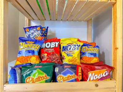 a pile of chips and other snacks on a shelf at Azure Staycation in Manila