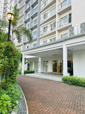 a building with a brick walkway in front of a building at Affordable Condo Near SM Southmall in Manila