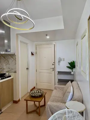a living room with a couch and a table at Positano 933 in Manila