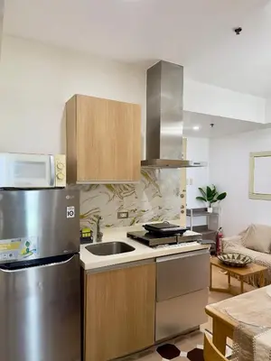 a kitchen with a stainless steel refrigerator and a sink at Positano 933 in Manila