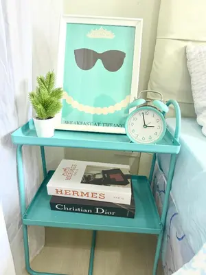 a blue end table with a clock and a picture at Positano 909 in Manila