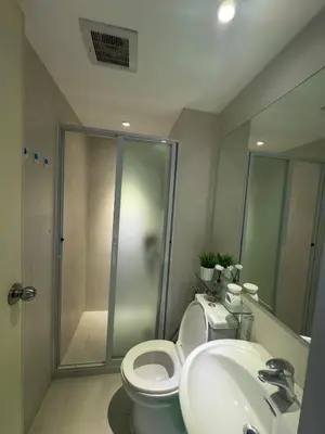 a bathroom with a shower and a toilet and a sink at Positano 909 in Manila