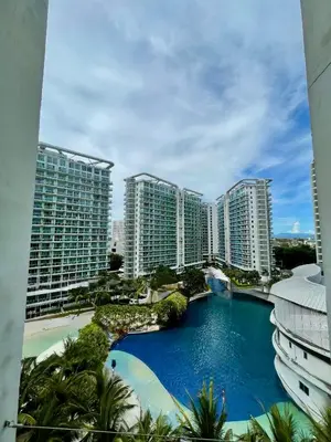 a view of a pool in front of tall buildings at Positano 909 in Manila