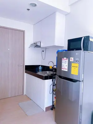 a kitchen with a refrigerator and a counter top at Eco Suite Hope Residences Trece in Trece Martires