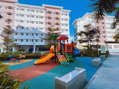 a playground in front of a building with a slide at Eco Suite Hope Residences Trece in Trece Martires