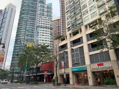a street in a city with tall buildings at Avant at the Fort King bed Central 5mins to Highstreet BGC in Manila