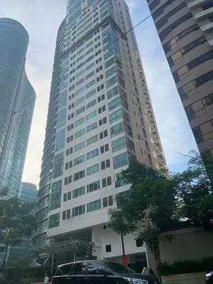 a tall building with cars parked in front of it at Avant at the Fort King bed Central 5mins to Highstreet BGC in Manila