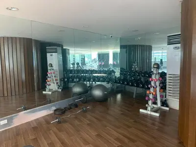a gym with a mirror and a lot of exercise equipment at Avant at the Fort King bed Central 5mins to Highstreet BGC in Manila