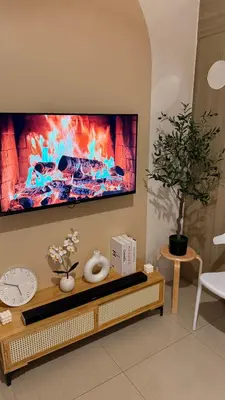 a living room with a tv on a wall at Shore Residences Haru Cozy pad Near Mall of Asia and Airport in Manila