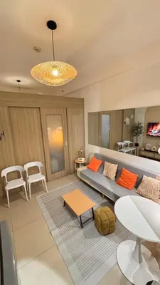 a living room with a couch and a table at Shore Residences Haru Cozy pad Near Mall of Asia and Airport in Manila