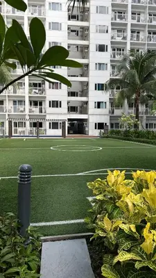 a soccer field in front of a large building at Shore Residences Haru Cozy pad Near Mall of Asia and Airport in Manila
