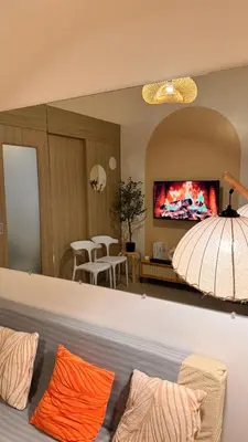 a living room with a large mirror above a couch at Shore Residences Haru Cozy pad Near Mall of Asia and Airport in Manila