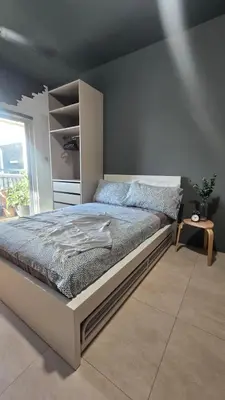 a bedroom with a large bed in a room at QuiHouse in Manila