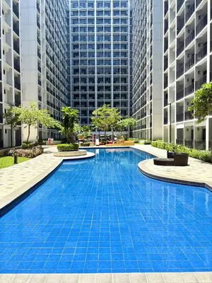 a large swimming pool with tall buildings in the background at Mall of Asia Casa de Lune at Shore 2 in Manila