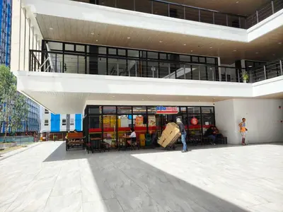 a person standing in front of a building at Urban Oasis for 7 with 200 mbps & Netflix in Manila