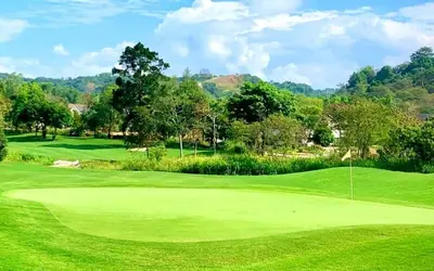 a view of a golf course with a green field at Urban Oasis for 7 with 200 mbps & Netflix in Manila