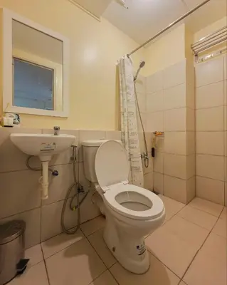 a bathroom with a toilet and a sink at Urban Oasis for 7 with 200 mbps & Netflix in Manila