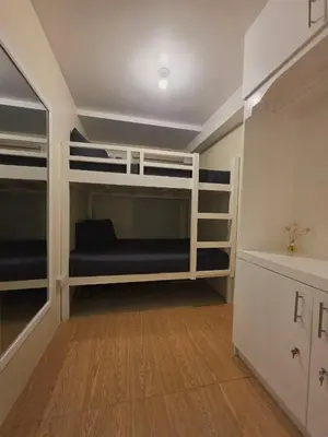 a bedroom with bunk beds in a room at Urban Oasis for 7 with 200 mbps & Netflix in Manila