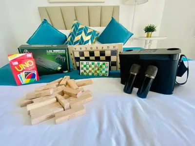 a group of wooden blocks on a bed with two microphones at SM Bicutan Condo by Santorini in Manila