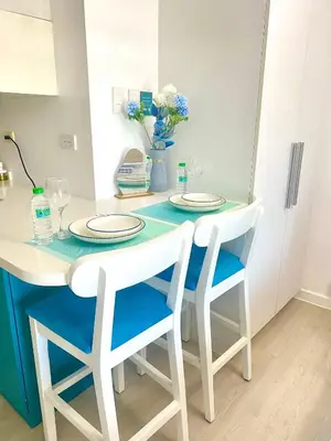 a table with two chairs and two plates on it at SM Bicutan Condo by Santorini in Manila