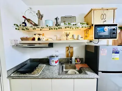 a small kitchen with a sink and a refrigerator at Paradise Staycation at South in Manila