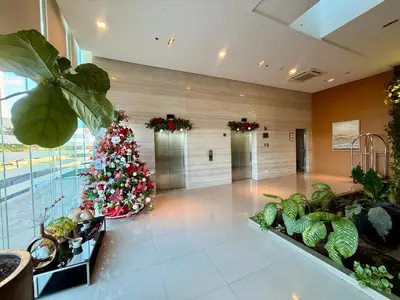 a lobby with a christmas tree in the middle of a room at Bright & Cozy High-Rise Condo in Pulong Cacawate