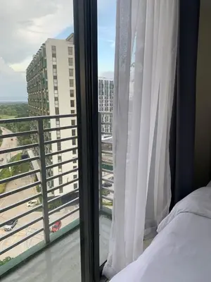 a bedroom with a bed and a window at Bright & Cozy High-Rise Condo in Pulong Cacawate