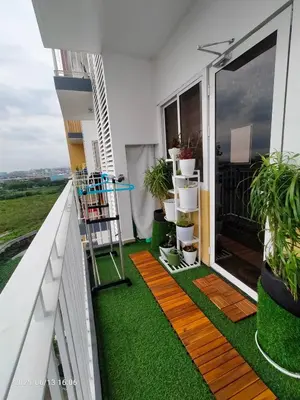 a balcony with green grass and plants on it at 1123 Field Res Condo by Bambie free drinking water in Manila