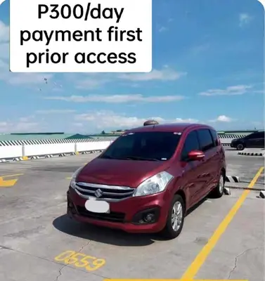 a red car parked in an airport parking lot at 1123 Field Res Condo by Bambie free drinking water in Manila