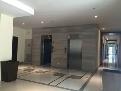 a lobby with two elevators in a building at One Palm Tree Condo in Manila