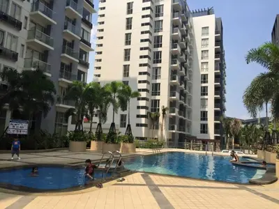 a swimming pool with two tall buildings in the background at One Palm Tree Condo in Manila