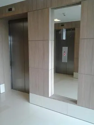 a lobby with two elevators in a building at One Palm Tree Condo in Manila