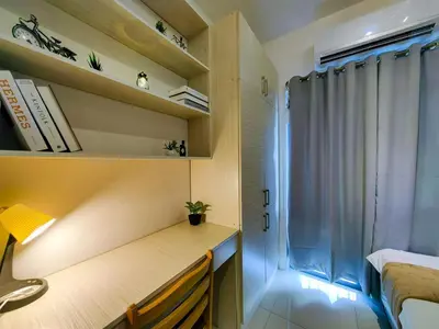 a small room with a desk and a window at 1BR Condotel with Balcony at FAME Residences #FM03-1 in Manila