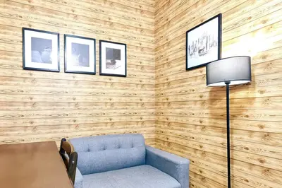 a living room with a blue couch and a table at 1BR Condotel with Balcony at FAME Residences #FM05-1 in Manila