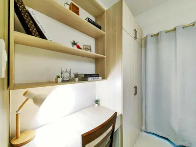 a small room with a desk and a shower at 1BR Condotel with Balcony at FAME Residences #FM06-1 in Manila