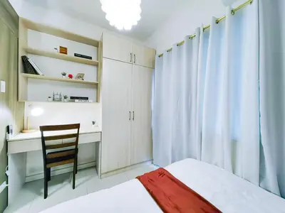 a bedroom with a bed and a desk and a chair at 1BR Condotel with Balcony at FAME Residences #FM06-1 in Manila