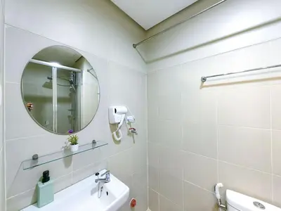 a white bathroom with a mirror and a sink at 1BR Condotel with Balcony at FAME Residences #FM07-1 in Manila
