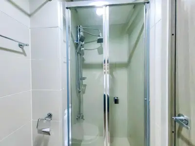 a shower with a glass door in a bathroom at 1BR Condotel with Balcony at FAME Residences #FM07-1 in Manila