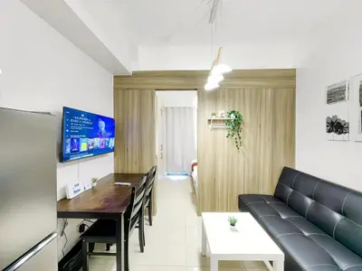 a living room with a couch and a table at 1BR Condotel with Balcony at FAME Residences #FM07-1 in Manila