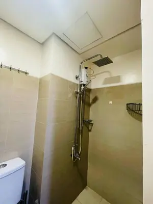 a shower in a bathroom with a toilet at Shore Residences Tower D in Manila