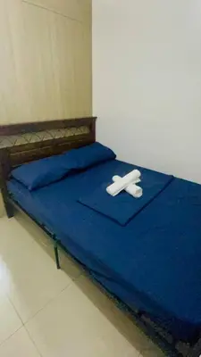 a bed with two white napkins on top of it at Shore Residences Tower D in Manila