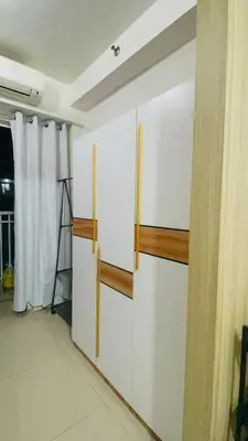 a room with white walls and wooden shelves at Shore Residences Tower D in Manila