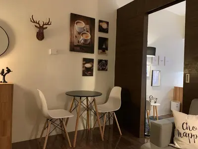 a dining room with a table and chairs at Makati City Ayala Ave Extension Condo with Fast Internet in Manila