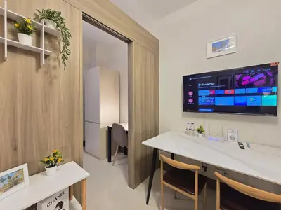 a room with a table and a tv on the wall at 1BR Condotel with Balcony at FAME Residences #FM10-1 in Manila