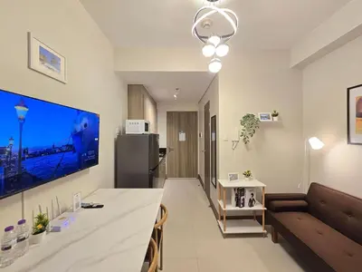 a living room with a table and a couch at 1BR Condotel with Balcony at FAME Residences #FM10-1 in Manila