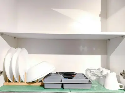 a kitchen with white plates on a counter at 1BR Condotel with Balcony at FAME Residences #FM11-1 in Manila