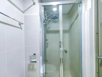 a shower with a glass door in a bathroom at 1BR Condotel with Balcony at FAME Residences #FM11-1 in Manila