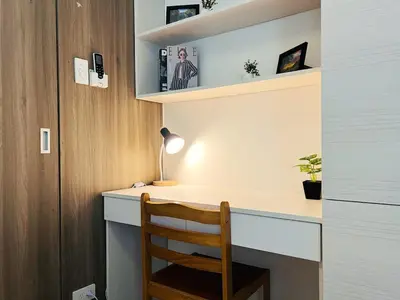 a room with a desk with a chair and a lamp at 1BR Condotel with Balcony at FAME Residences #FM12-1 in Manila