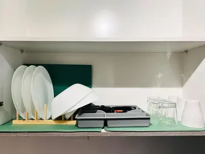 a kitchen counter with plates on a shelf at 1BR Condotel with Balcony at FAME Residences #FM12-1 in Manila